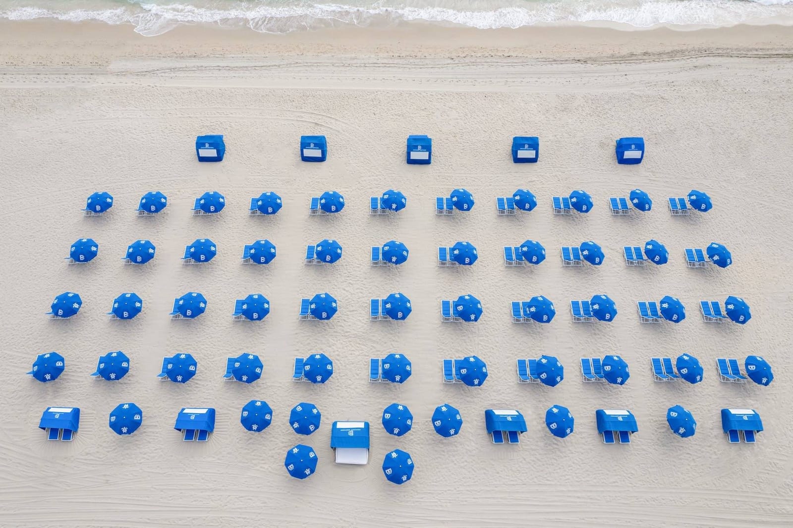 Organized beach with rows of umbrellas